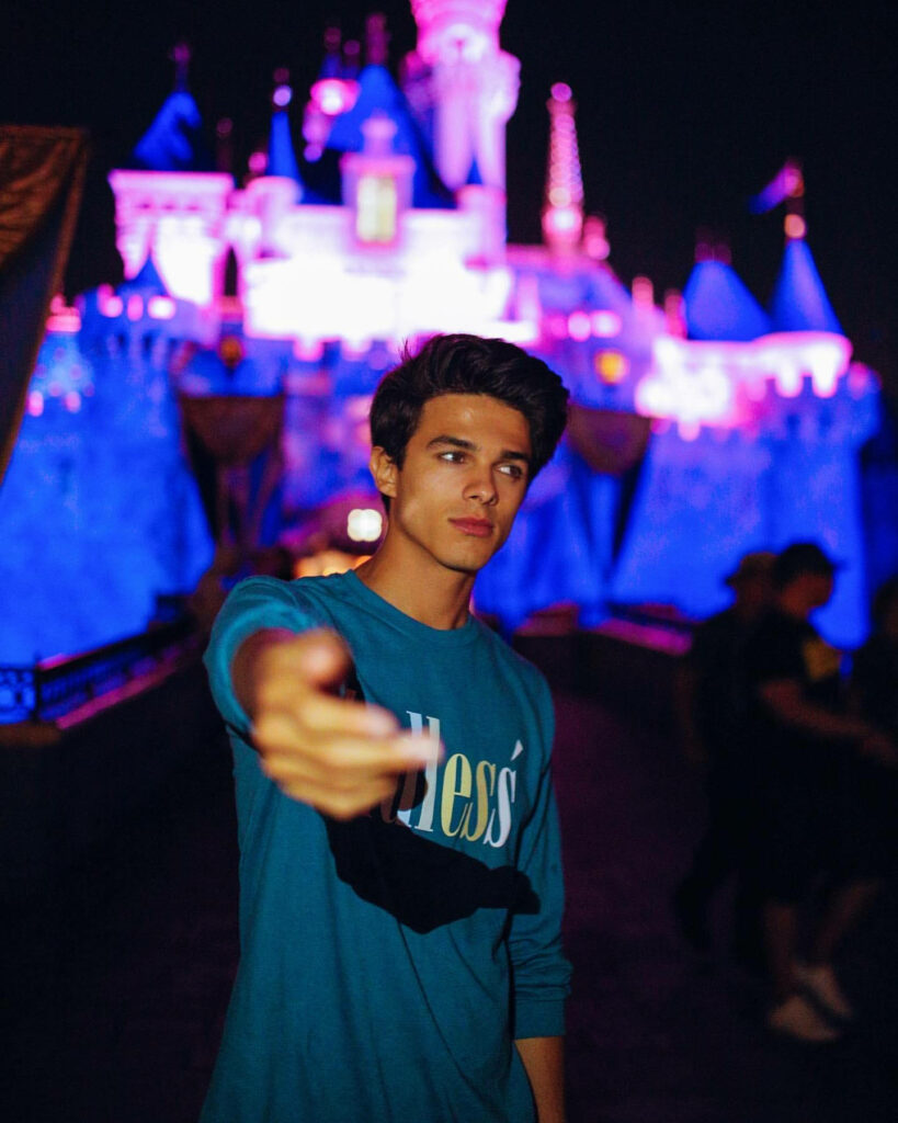 Brent Rivera YouTuber wallpaper with vibrant neon pink and blue lit castle background at night