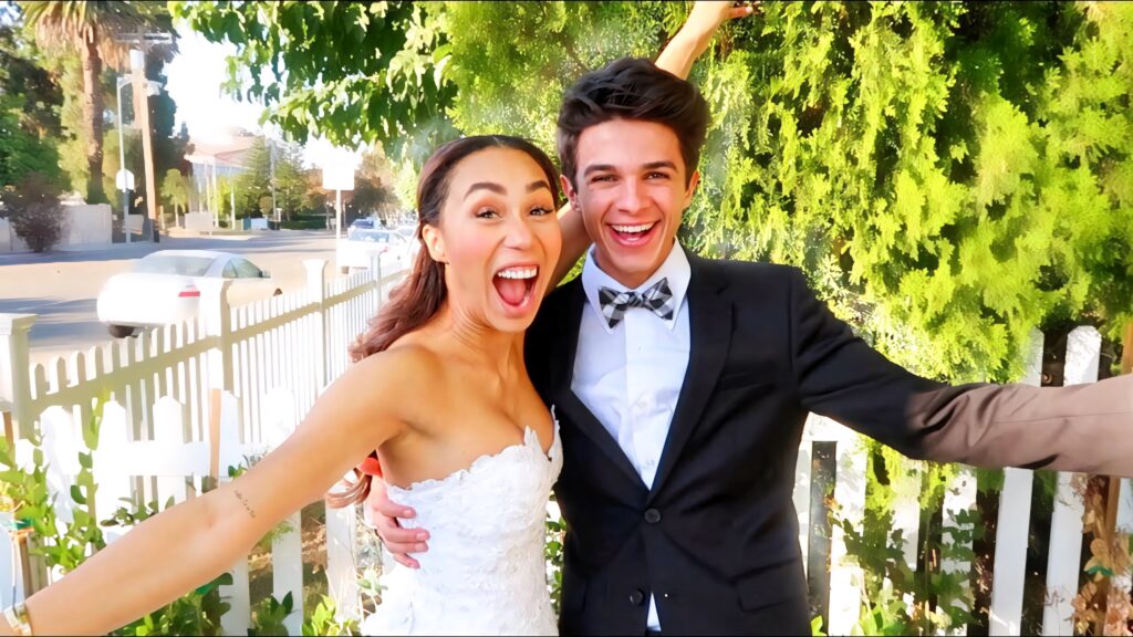 Brent Rivera and Eva Gutowski wedding photo outdoor lush greenery white picket fence wallpaper