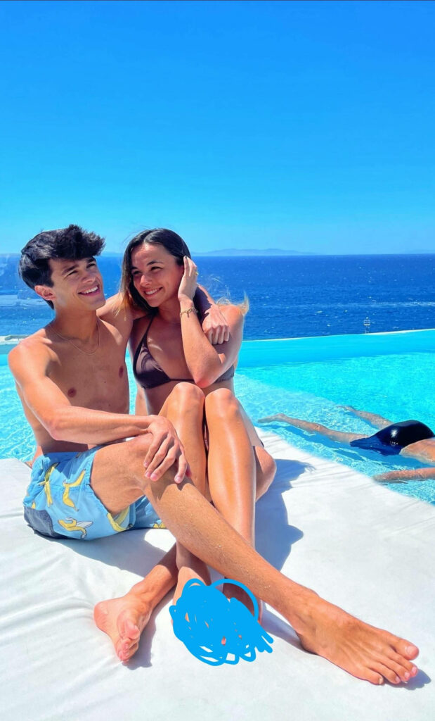 Brent and Lexi Rivera by infinity pool ocean view sunny day vibrant summer sibling bond wallpaper