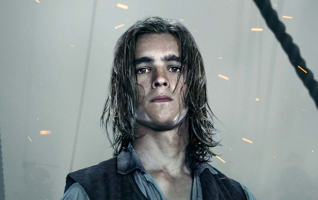 Brenton Thwaites cinematic portrait with long hair rugged attire misty background sparks flying Wallpaper