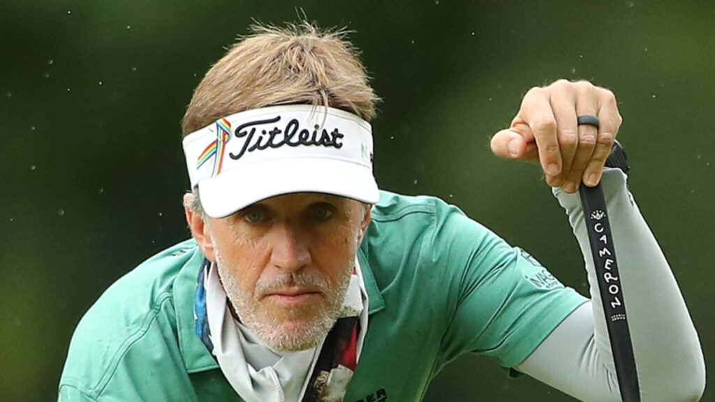 Brett Quigley focused golf close-up green shirt Titleist visor holding club motivational wallpaper