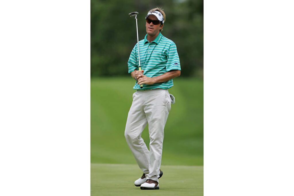 Brett Quigley standing casually on golf course green polo shirt golf club sports wallpaper