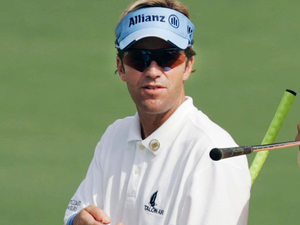 Brett Quigley wearing Allianz visor and sunglasses on green golf course with white polo shirt Wallpaper