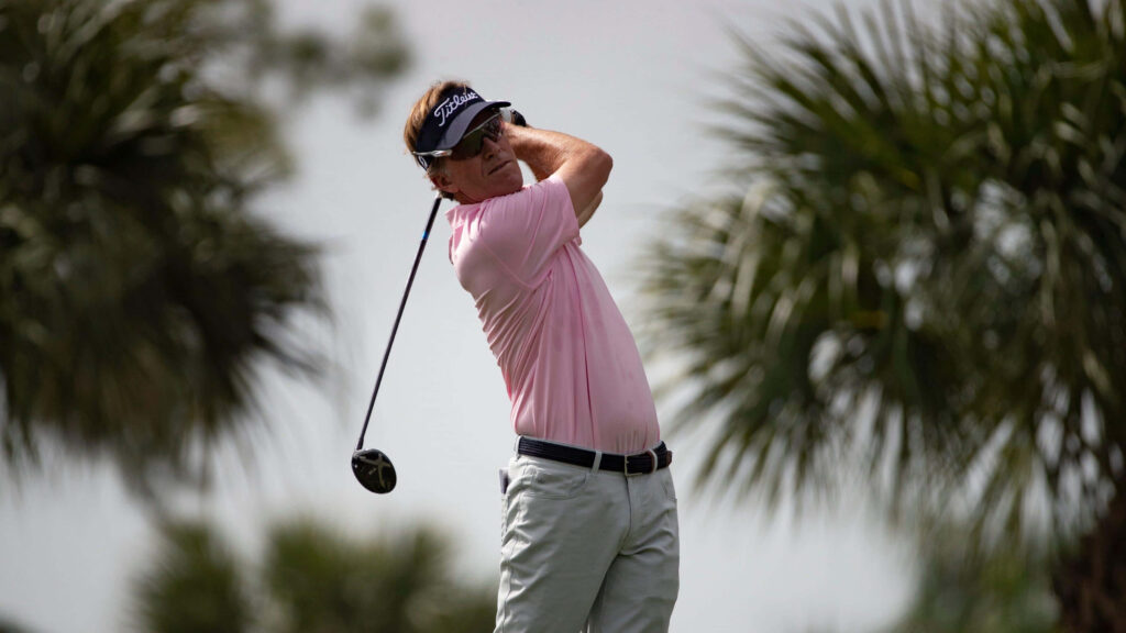 Brett Quigley golf swing follow through pink polo grey cap sunny course palm trees wallpaper background