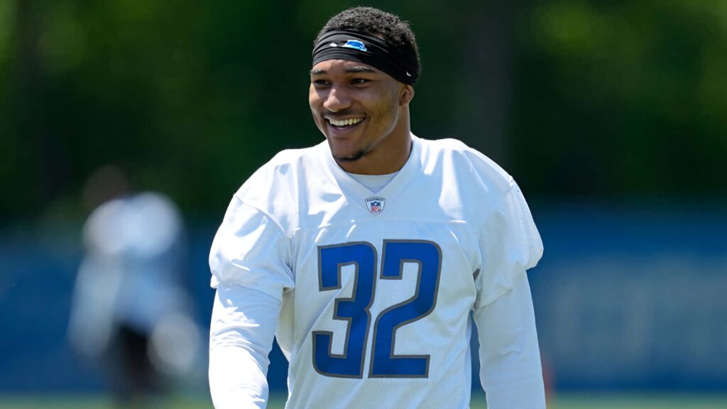 Brian Branch Detroit Lions in white training jersey number 32 on bright outdoor practice field wallpaper