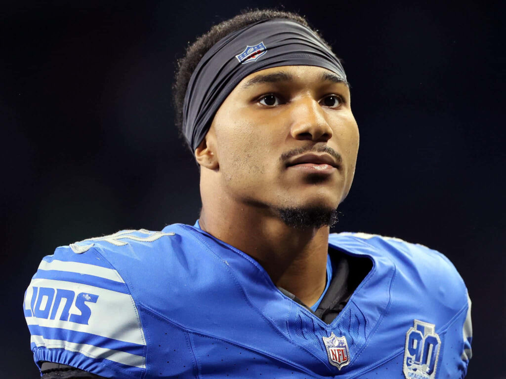 Brian Branch Detroit Lions player in blue jersey sharp focused vibrant football wallpaper background