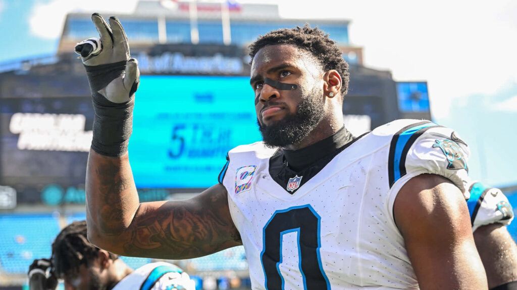 Brian Burns Carolina Panthers celebrating on field in full uniform with vibrant stadium background Wallpaper