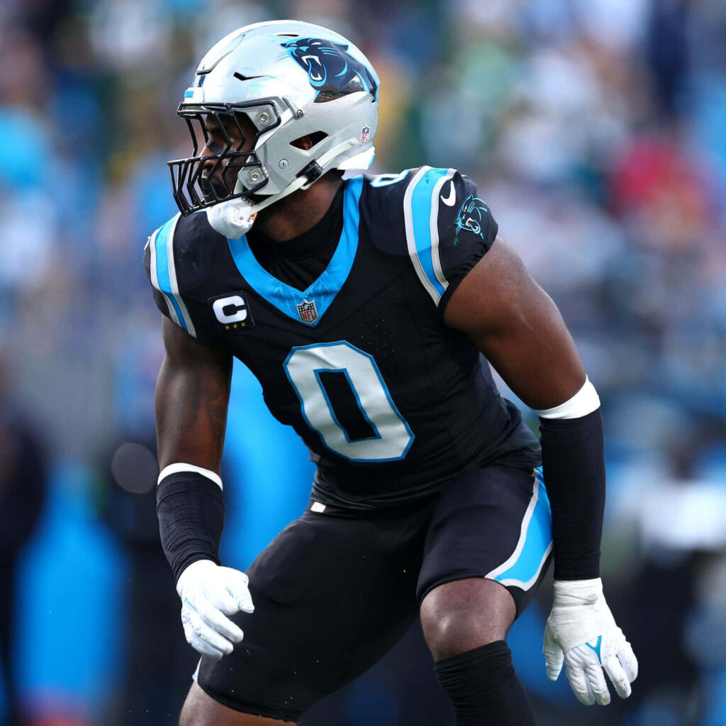 Brian Burns Carolina Panthers defensive end intense action pose vibrant team colors wallpaper