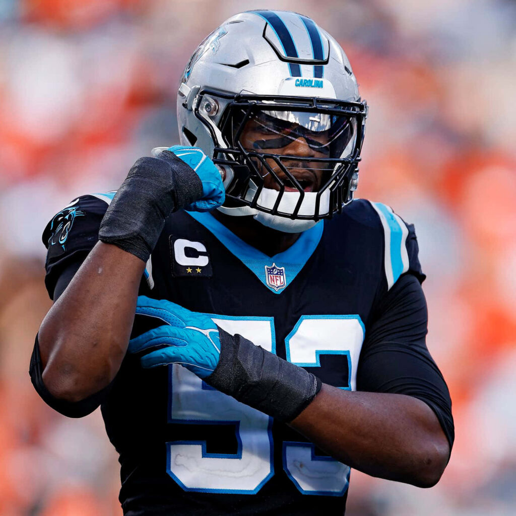 Carolina Panthers captain Brian Burns in full gear showing intensity and leadership on field Wallpaper