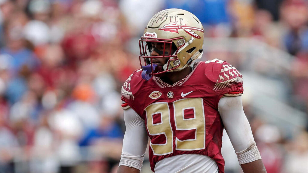 Brian Burns number 99 in maroon and gold uniform intense football action HD wallpaper background