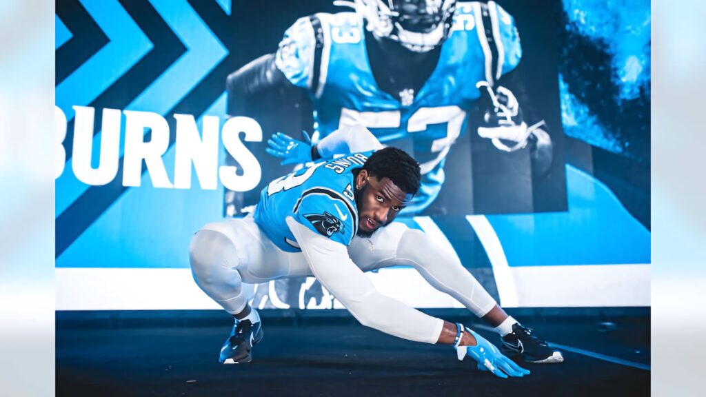 Brian Burns in Carolina Panthers defensive stance intense focus blue black white NFL wallpaper background
