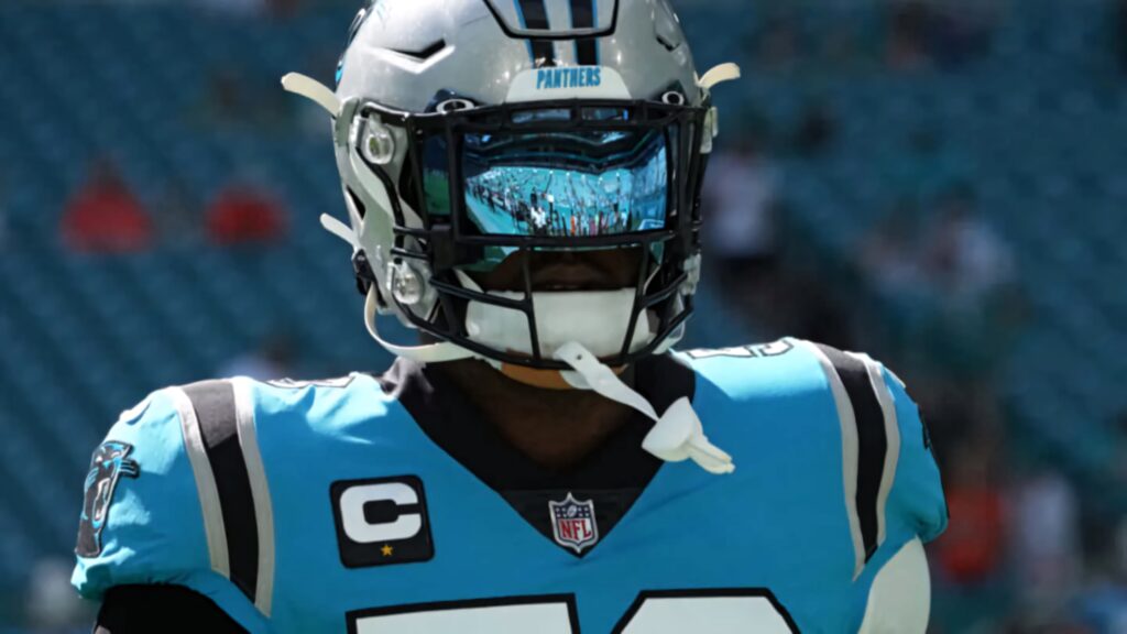 Panthers Brian Burns close-up action with visor reflection in teal and black uniform wallpaper