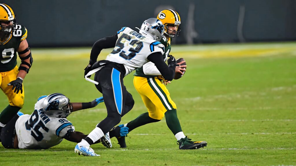 Brian Burns sacking Packers quarterback intense football action Carolina Panthers NFL wallpaper