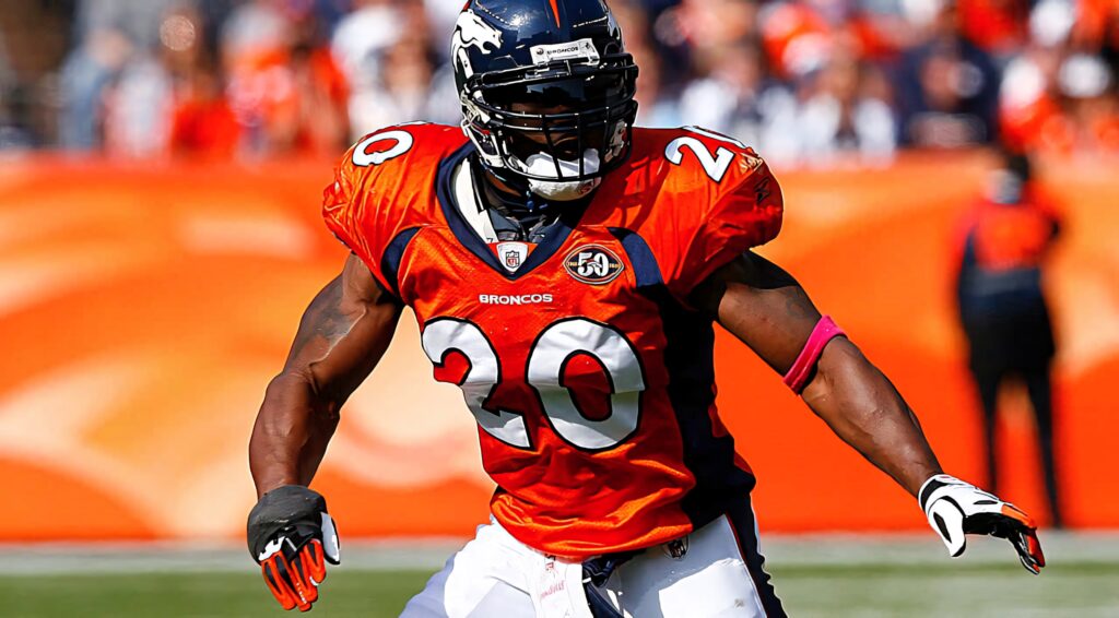 Brian Dawkins Denver Broncos number 20 action shot mid-play vibrant orange navy football field Wallpaper