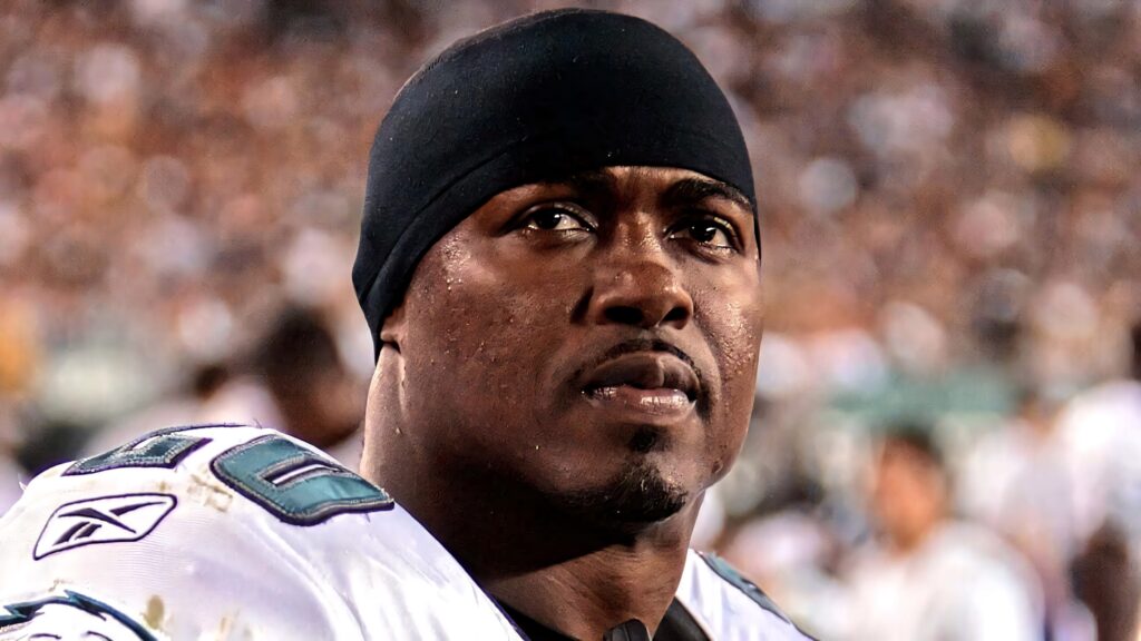 Brian Dawkins focused in Eagles uniform HD wallpaper vibrant colors dynamic football background