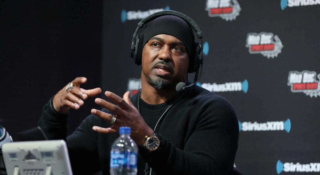 Brian Dawkins Sirius XM interview in radio studio wearing black sweater and beanie headset Wallpaper