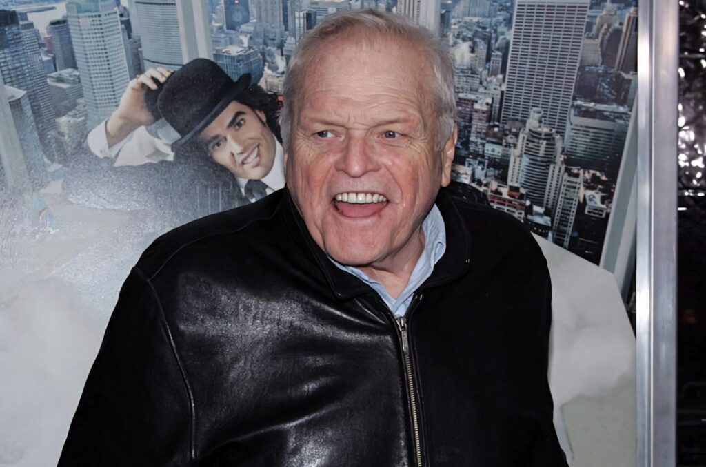 Brian Dennehy in black leather jacket against vibrant city skyline high resolution wallpaper