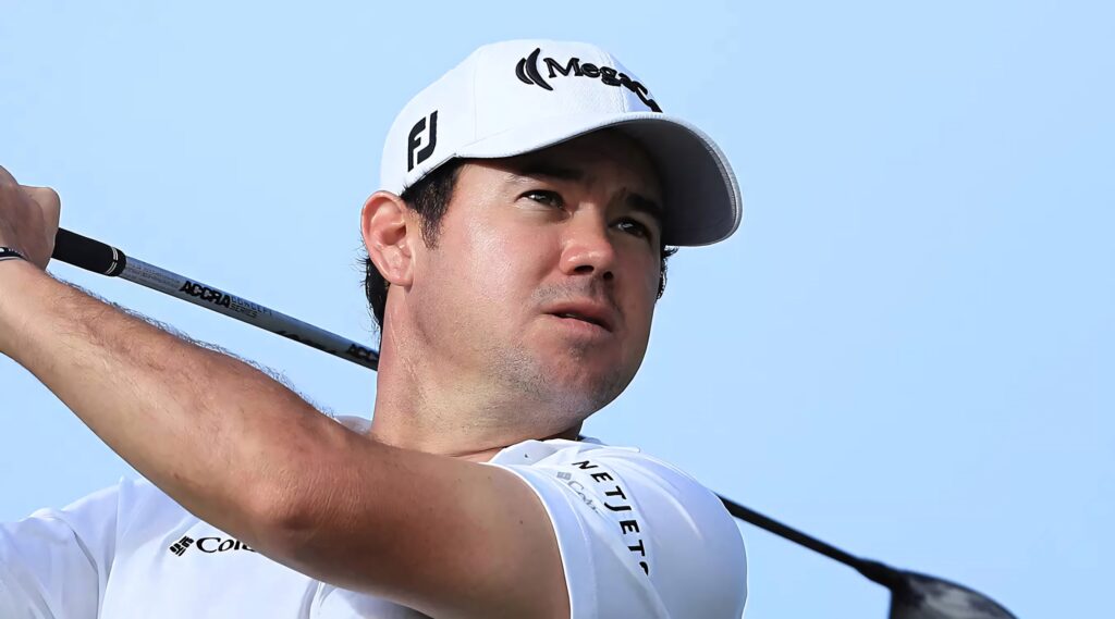 Brian Harman mid-swing golf wallpaper with dynamic motion and blue sky background for golf fans
