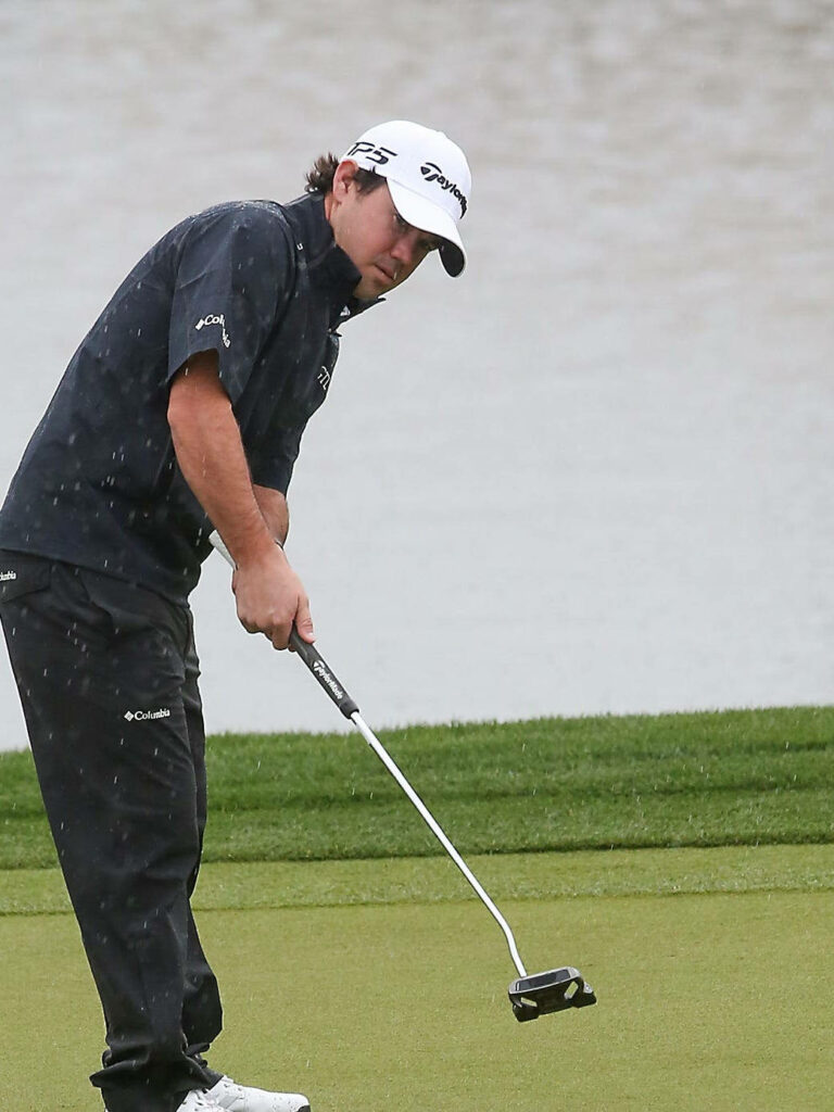 Brian Harman golf tee shot focused swing Taylormade cap dark attire lush green course wallpaper