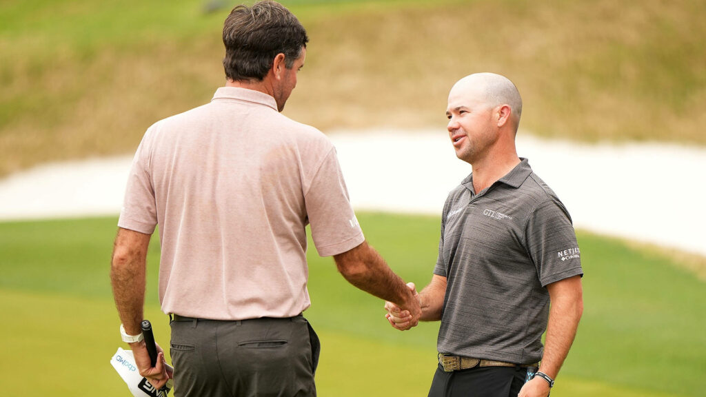 Brian Harman handshake on golf course lush green background professional sports wallpaper