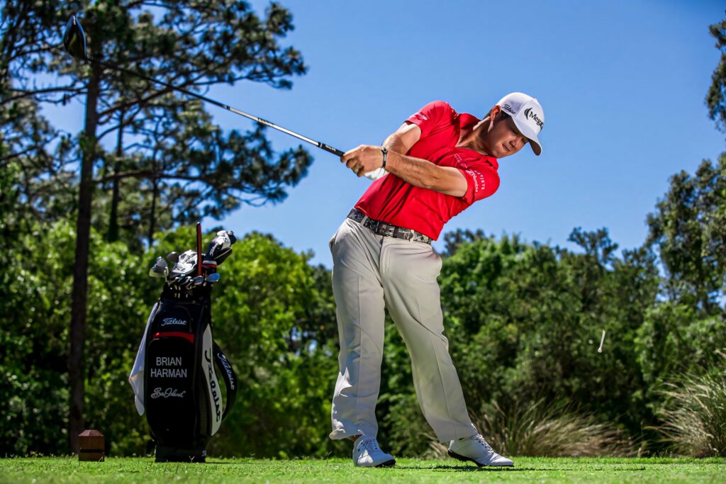Brian Harman mid-swing golf shot bright sunny day blue sky green golf course wallpaper