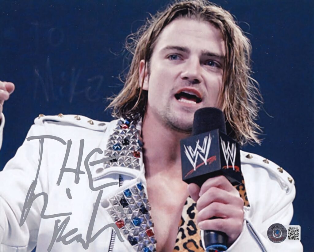 Brian Kendrick WWE microphone wallpaper in studded white jacket with blue arena background