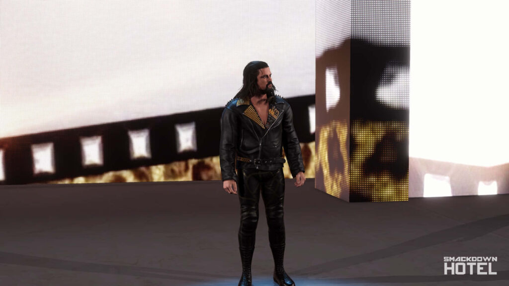Brian Kendrick in black leather jacket on digital stage with warm golden lighting WWE wallpaper