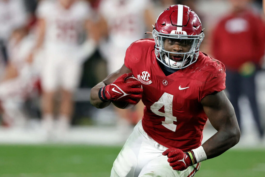 Brian Robinson Jr Alabama Football running back in crimson jersey intense game play action wallpaper