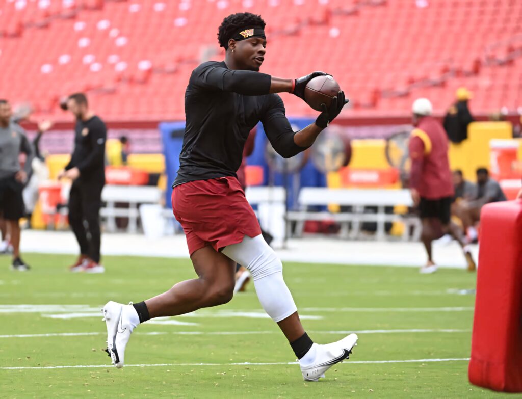 Brian Robinson Jr catching football during warmup in red and gold stadium sports wallpaper