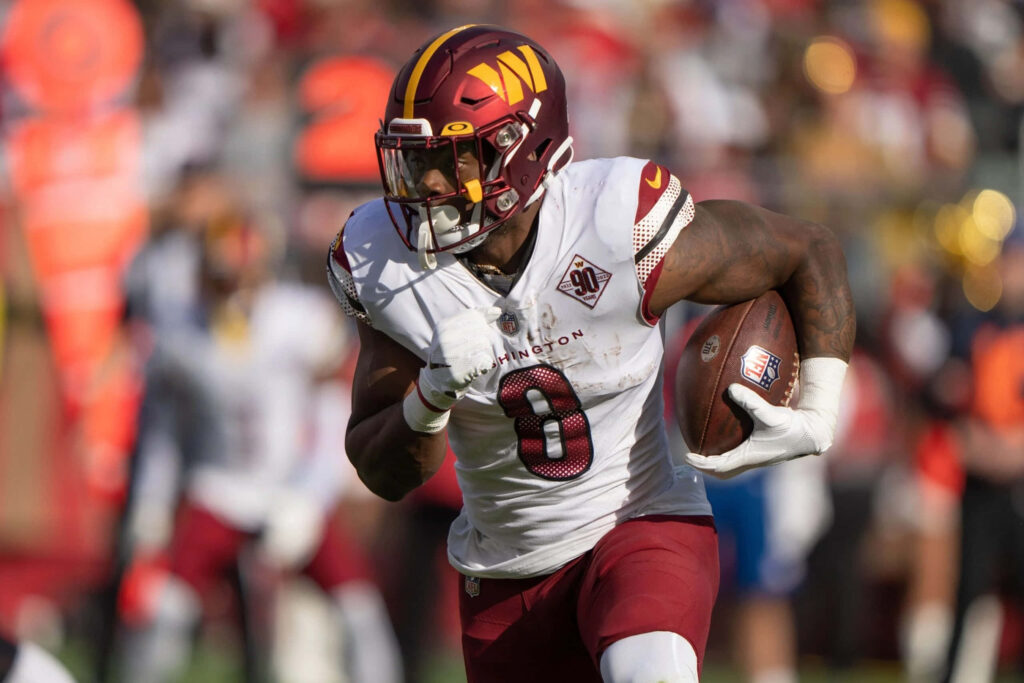 Brian Robinson Jr Washington Football powerful run action jersey 8 vibrant stadium wallpaper