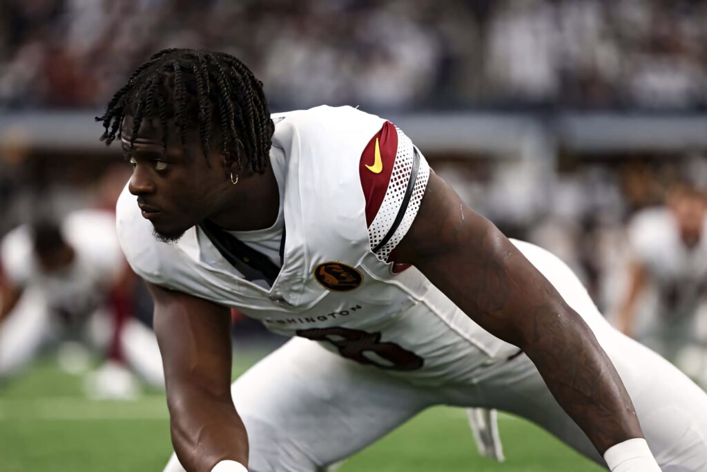 Washington Football Brian Robinson Jr in focused ready stance crisp white burgundy uniform wallpaper