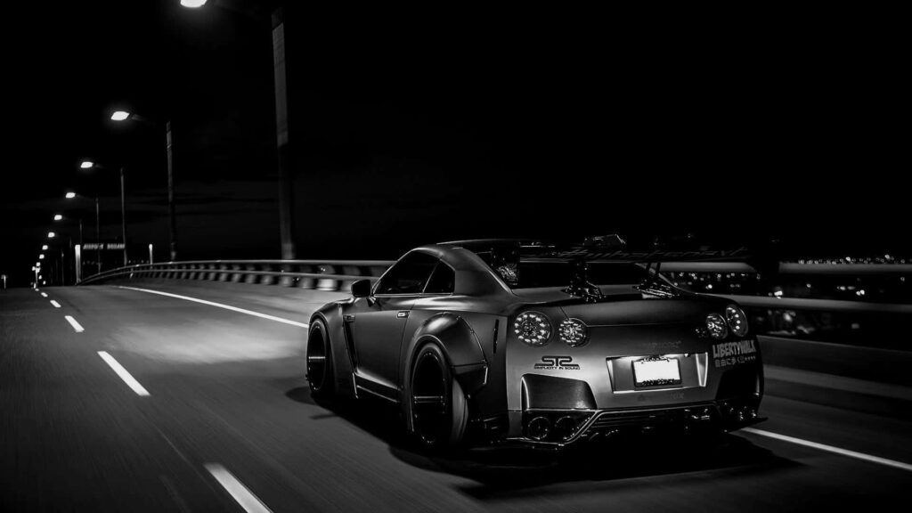 Cruising in Monochrome: Stunning GT-R Driving Across the Bridge - Sleek Desktop Background Wallpaper