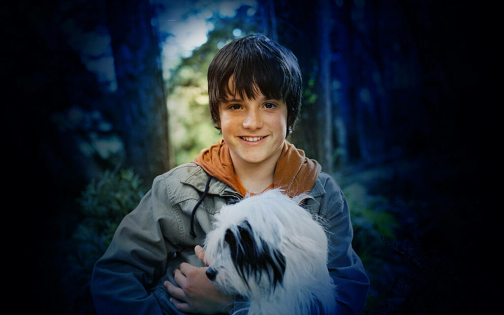 Josh Hutcherson Bridge to Terabithia wallpaper with smiling actor holding black and white dog