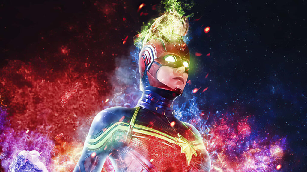 Brie Larson suits up as the fierce Captain Marvel, fighting intergalactic kree villains in an iconic red, blue, and gold superhero attire - a powerful display. Wallpaper