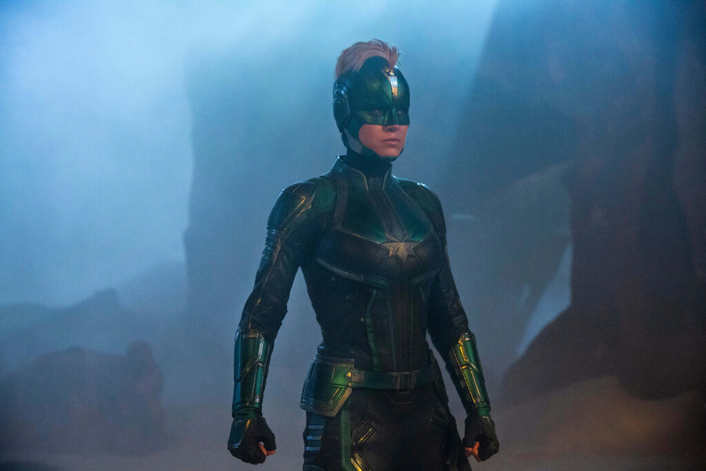 Brie Larson embodies the mighty Captain Marvel, defending the universe in her powerful red, blue, and gold ensemble Wallpaper