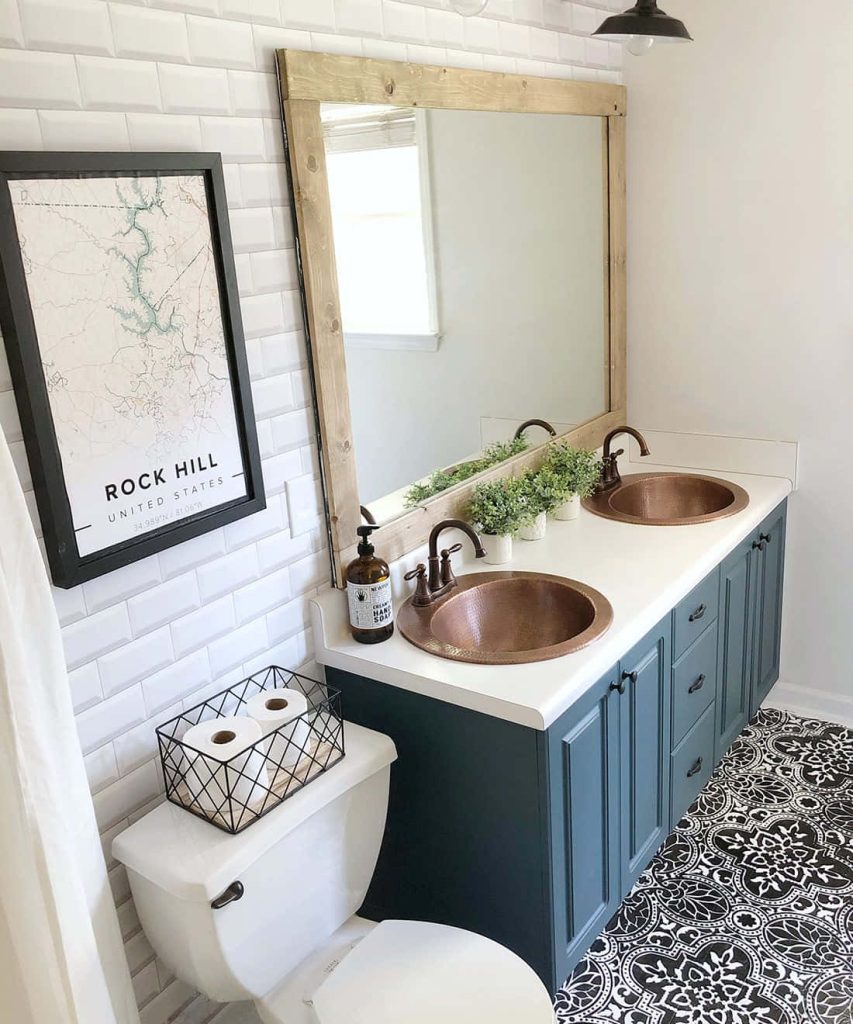 Bright bathroom with blue double vanity copper sinks black white patterned floor and rustic mirror Wallpaper