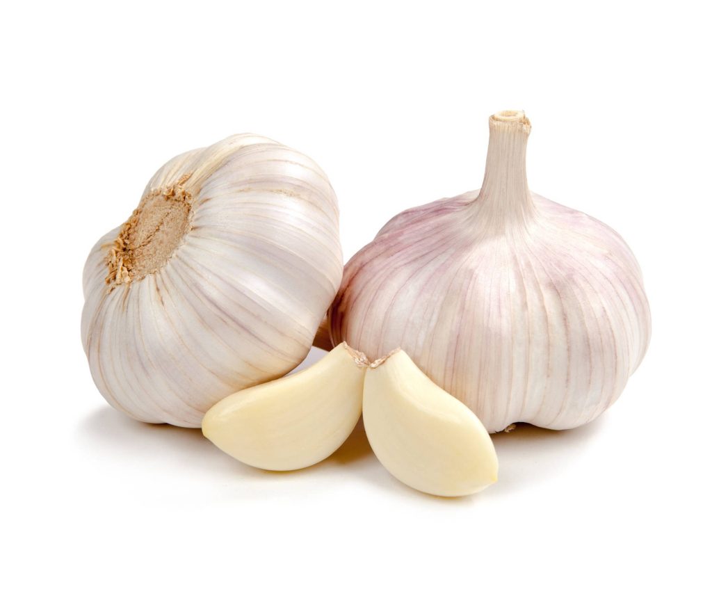 Two garlic bulbs and peeled cloves on white background showcasing fresh organic garlic textures Wallpaper