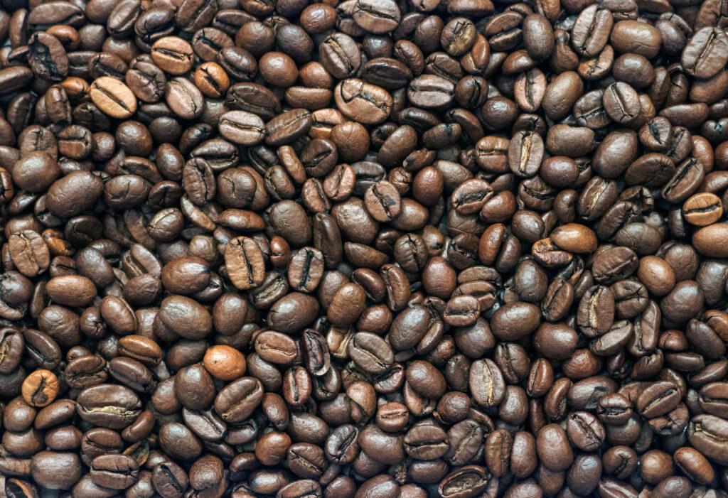 Close-Up Glossy Coffee Beans Wallpaper: Rich, Textured Background