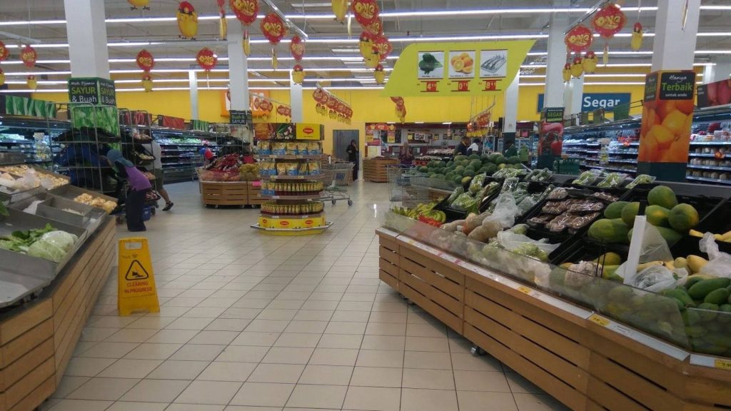 Bright spacious grocery store wallpaper with fresh produce wooden shelves and red lanterns lighting
