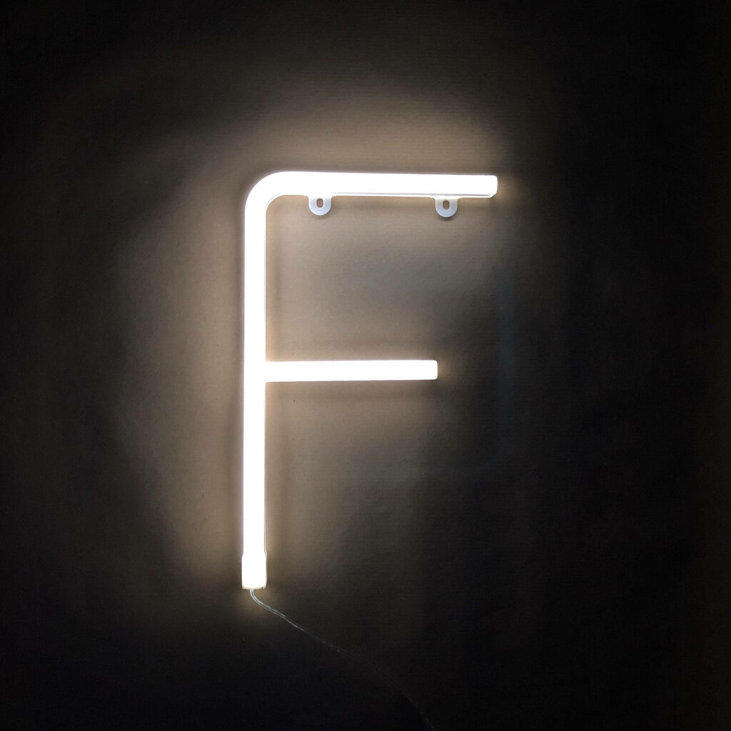 Neon white letter F on dark modern minimalist wallpaper background for typography lovers