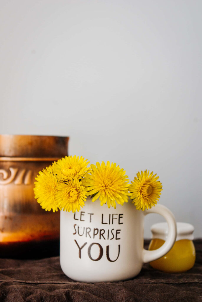 Bright Yellow Flowers in White Mug - Let Life Surprise You Wallpaper