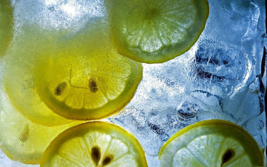 Vibrant Lemon Slice Wallpaper: Bright Citrus Ice Background