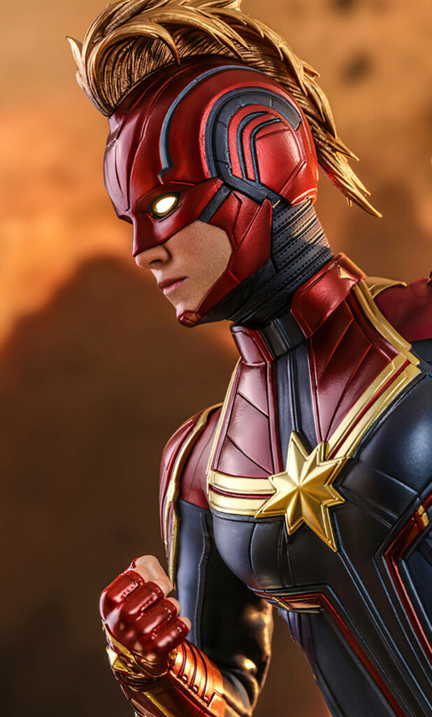 Powerfully Masked: An Exceptional Digital Rendition of Captain Marvel's Iconic Carol Danvers, Sporting a Striking Mohawk Hairstyle in a Captivating Side-profile Shot Wallpaper