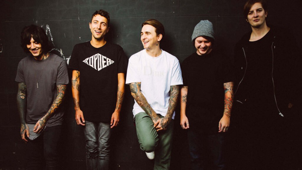 Bring Me The Horizon band members laughing together on dark background wallpaper image