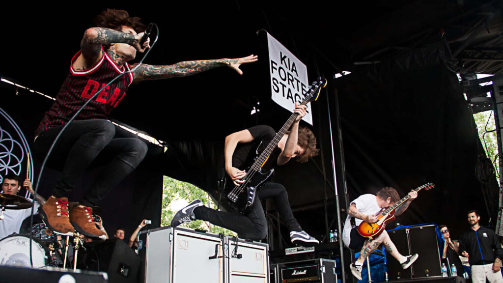 Bring Me The Horizon live concert high energy rock band members jumping on stage wallpaper