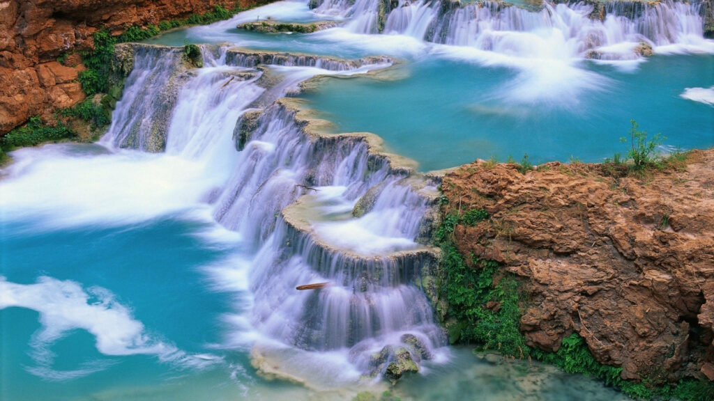 A Serene Oasis: Immerse Your Electronic Spaces with Nature's Charm - Mesmerizing Moving Desktop Waterfall Background Wallpaper