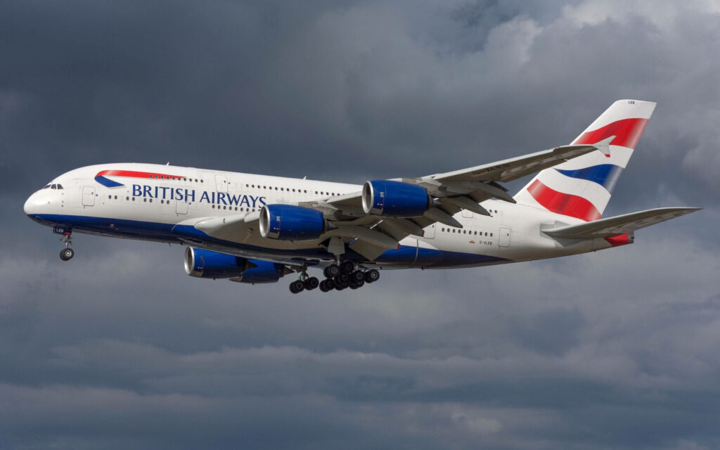 British Airways Airbus A380 in flight over dramatic sky featuring signature blue red white livery Wallpaper