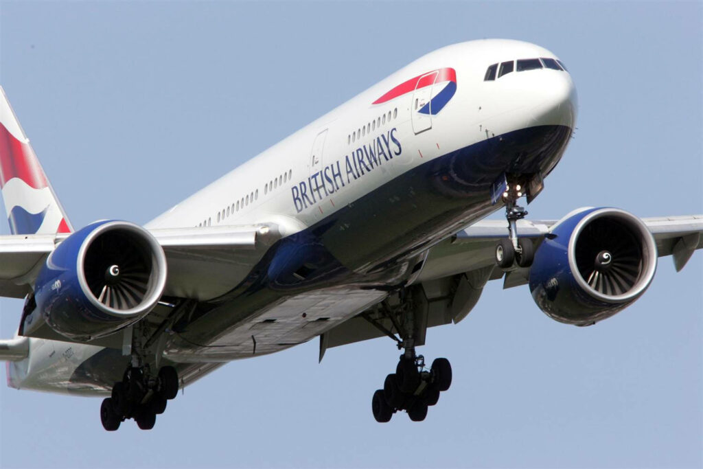 Close up of British Airways airplane ascending with detailed engines and vibrant blue red livery Wallpaper