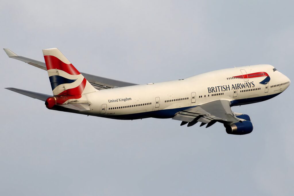 British Airways Boeing 747 400 jumbo jet in flight with blue underbelly and red white blue tailfin Wallpaper