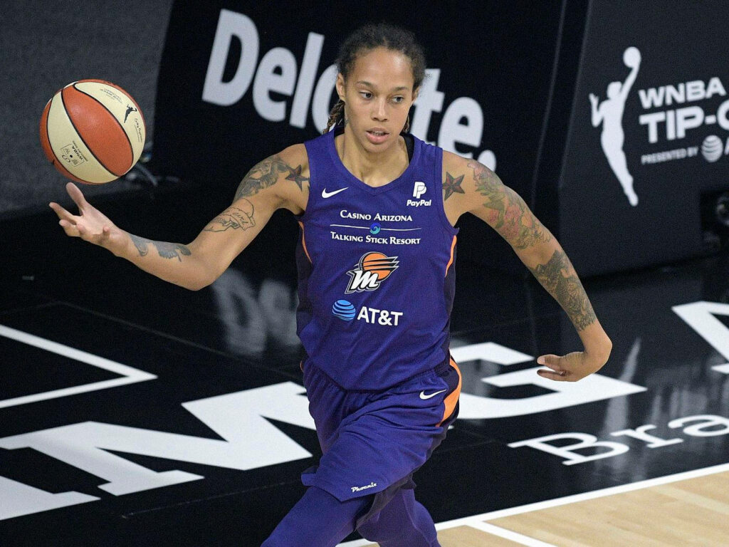 Brittney Griner throwing basketball in Phoenix Mercury jersey dynamic WNBA action wallpaper